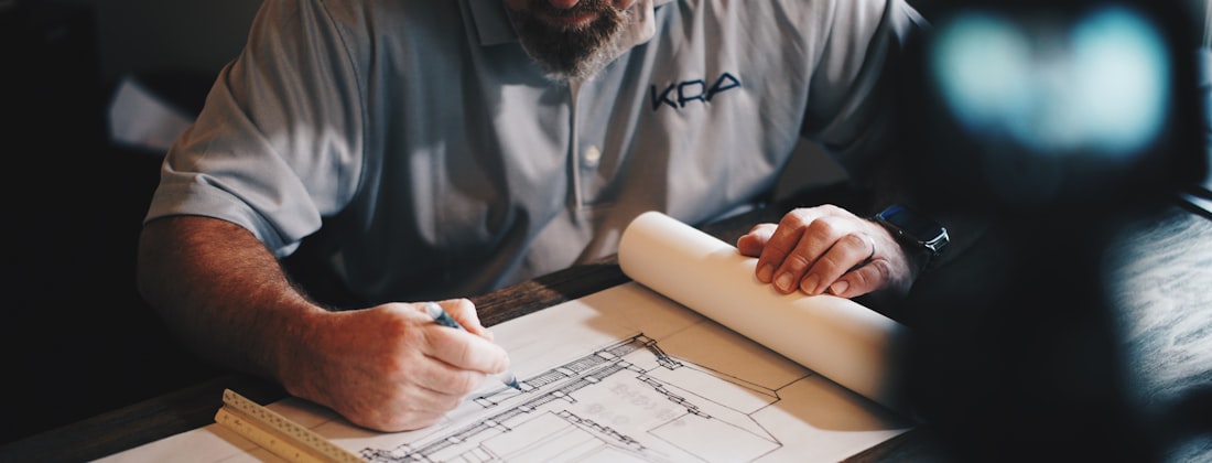A builder marking up drawings on site